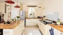 The kitchen adds a modern twist and the six door Aga is a lovely feature.