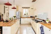 The kitchen adds a modern twist and the six door Aga is a lovely feature.