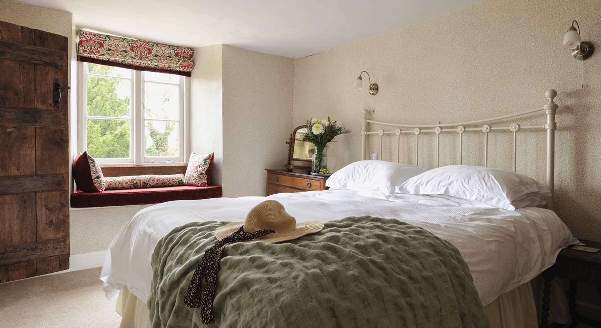 This lovely bedroom has a sweet window seat - the perfect spot to lose yourself in a good read.