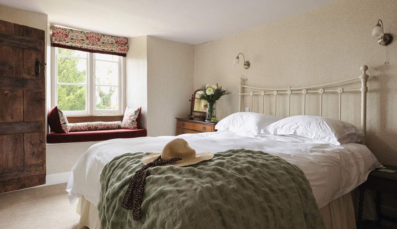 This lovely bedroom has a sweet window seat - the perfect spot to lose yourself in a good read.