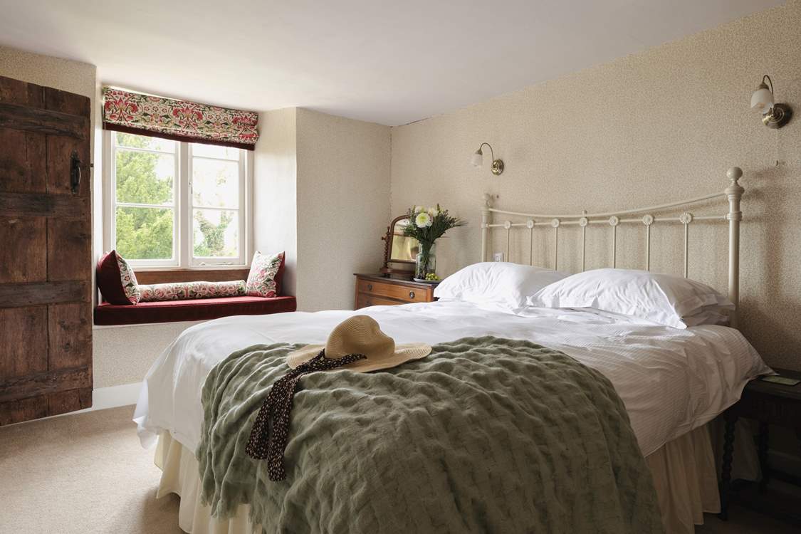 This lovely bedroom has a sweet window seat - the perfect spot to lose yourself in a good read.