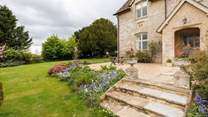 There is a pretty lawned area to the front and side of the property.