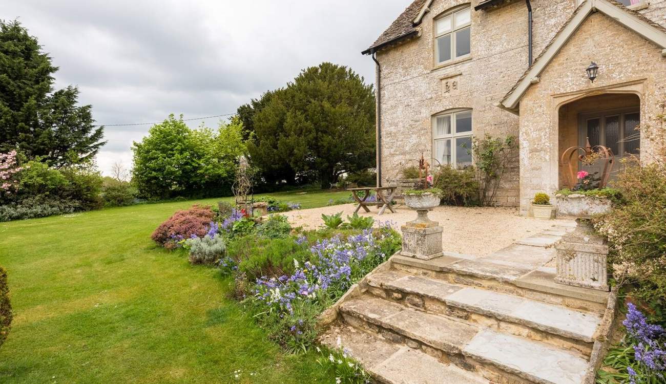 There is a pretty lawned area to the front and side of the property.