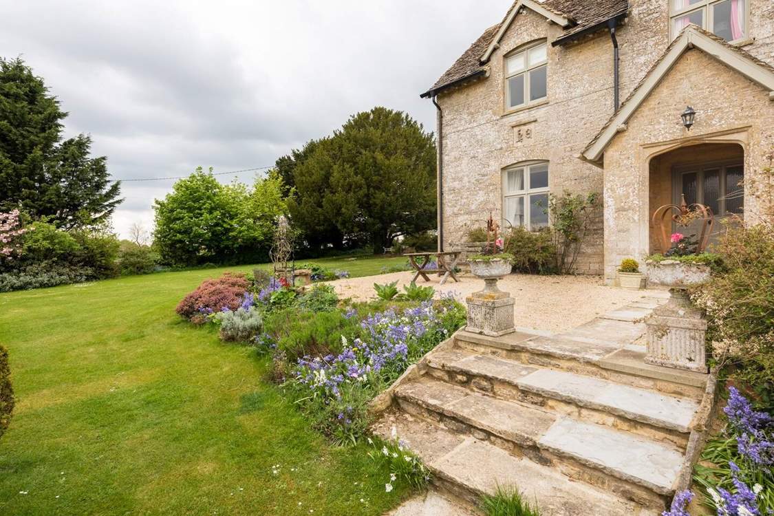 There is a pretty lawned area to the front and side of the property.