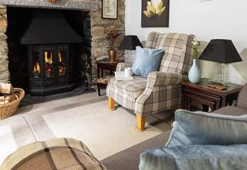 The wood-burning stove is a welcome sight in the cottage sitting-room.
