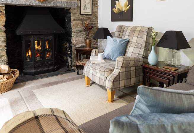 The wood-burning stove is a welcome sight in the cottage sitting-room.