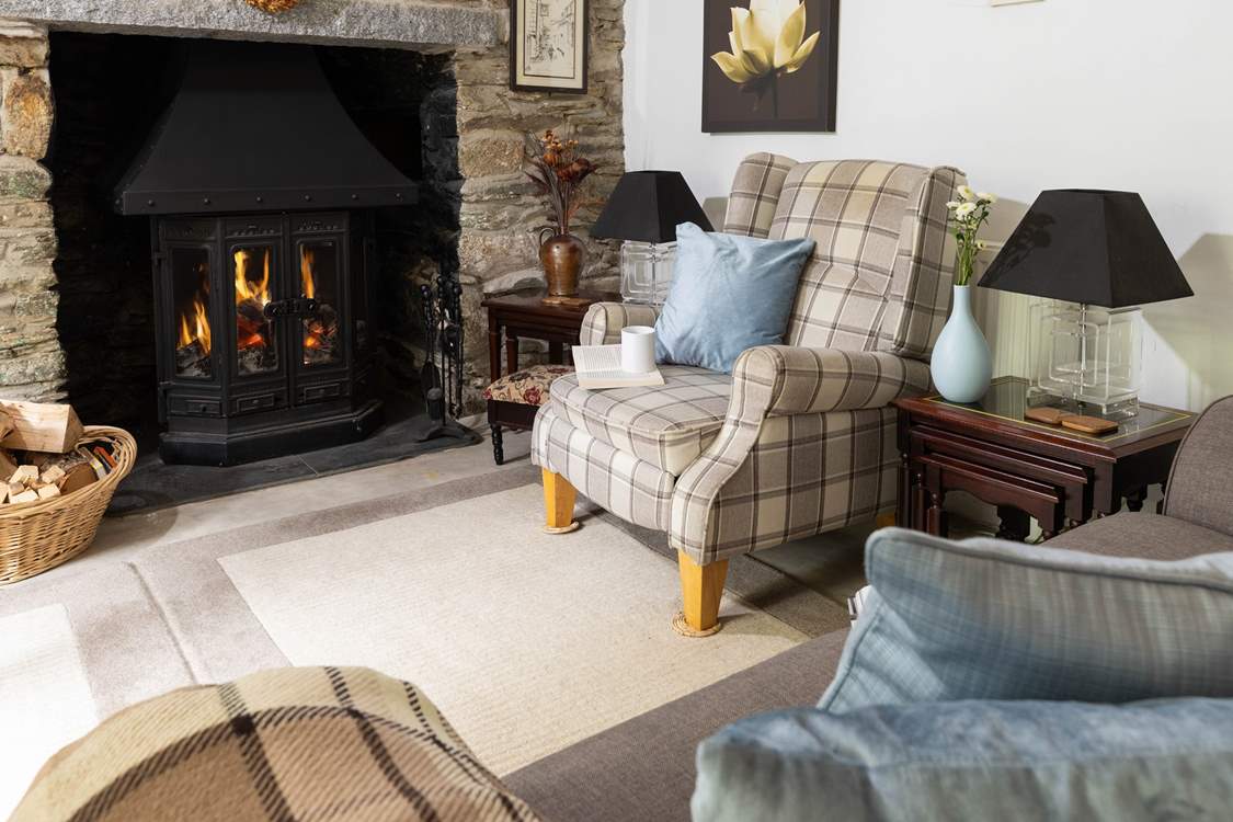 The wood-burning stove is a welcome sight in the cottage sitting-room.
