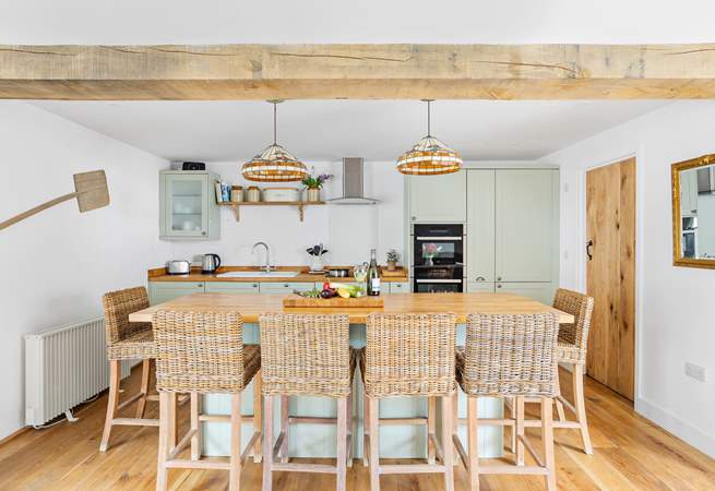 The stylish kitchen has a lovely island, the perfect spot for a catch up whilst the chef works their culinary magic.