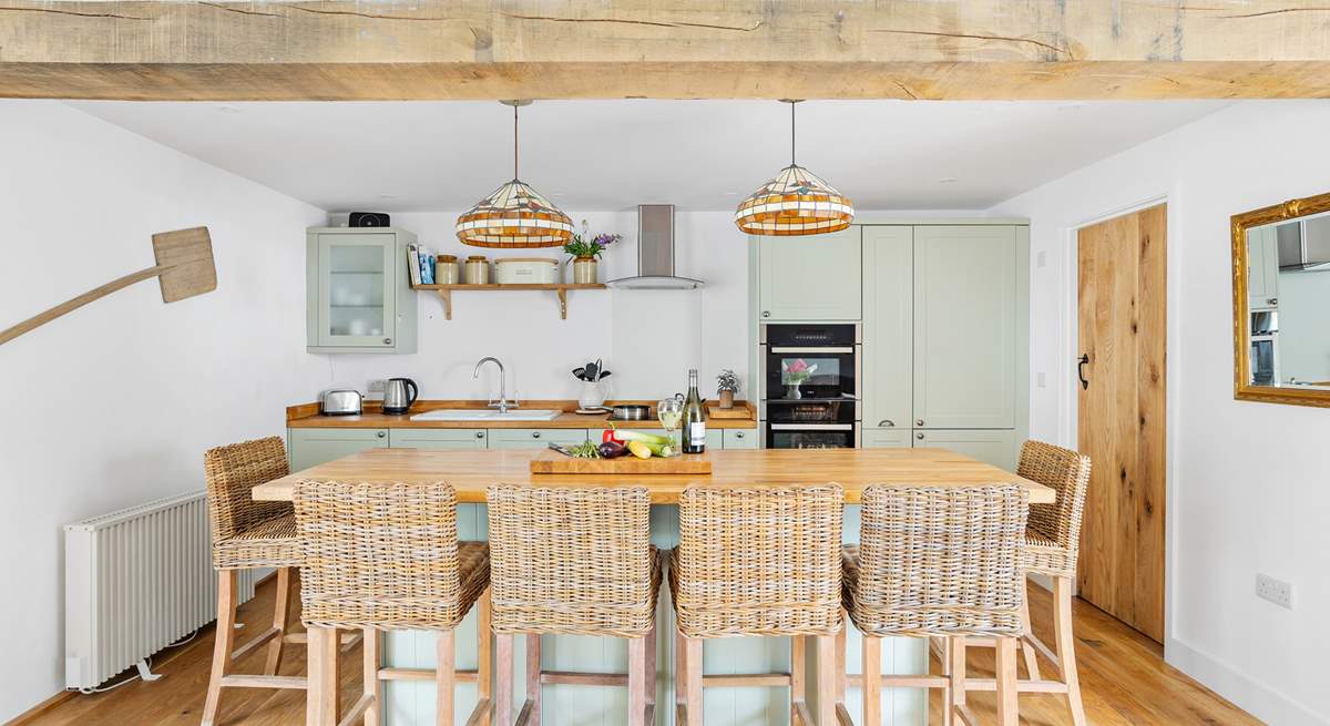 The stylish kitchen has a lovely island, the perfect spot for a catch up whilst the chef works their culinary magic.