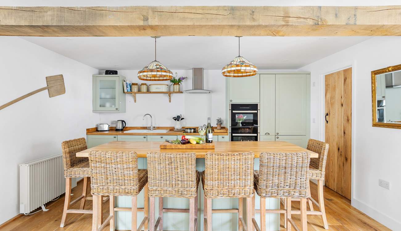 The stylish kitchen has a lovely island, the perfect spot for a catch up whilst the chef works their culinary magic.