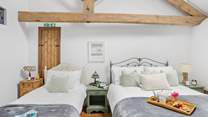 Even with two beds there is plenty of room in this vaulted ceiling bedroom.