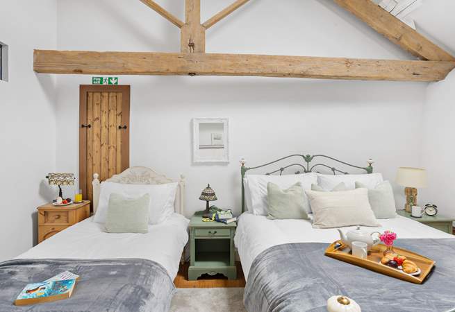Even with two beds there is plenty of room in this vaulted ceiling bedroom.