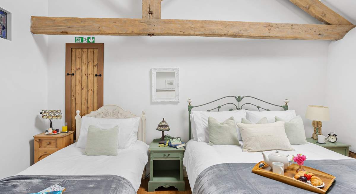 Even with two beds there is plenty of room in this vaulted ceiling bedroom.