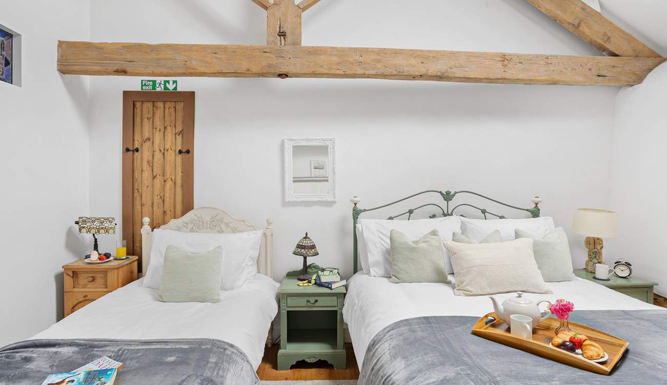 Even with two beds there is plenty of room in this vaulted ceiling bedroom.