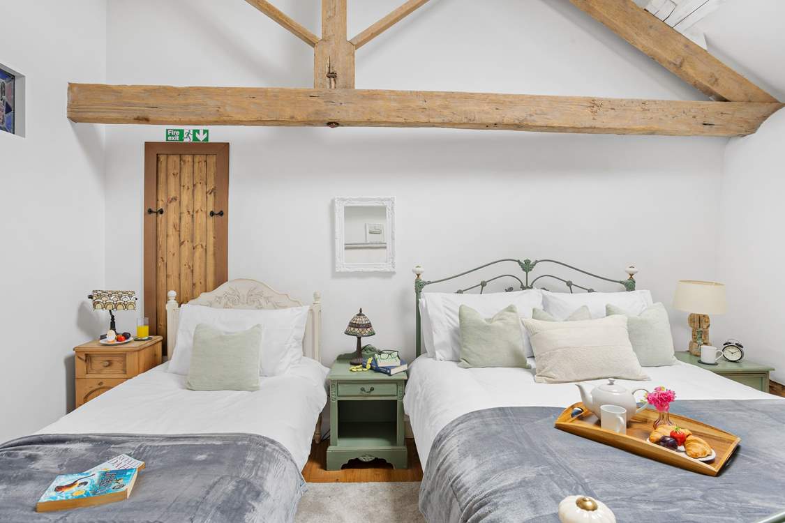 Even with two beds there is plenty of room in this vaulted ceiling bedroom.