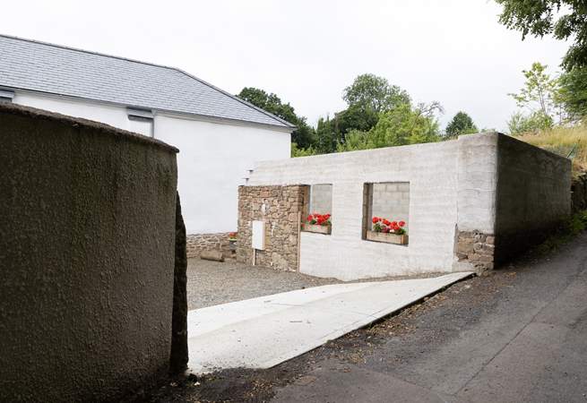 Pull off the lane into the parking courtyard.  Please note the building works have ceased with just the shell being visible. 