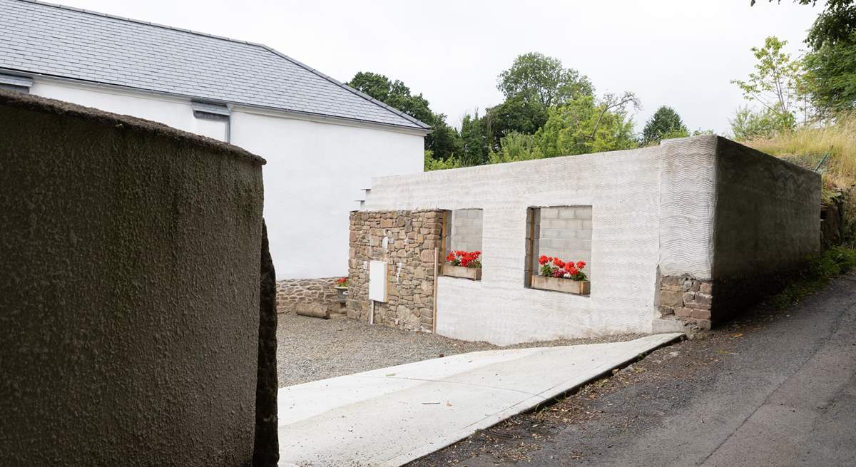 Pull off the lane into the parking courtyard.  Please note the building works have ceased with just the shell being visible. 