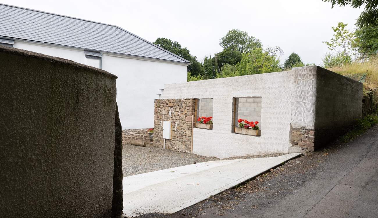 Pull off the lane into the parking courtyard.  Please note the building works have ceased with just the shell being visible. 