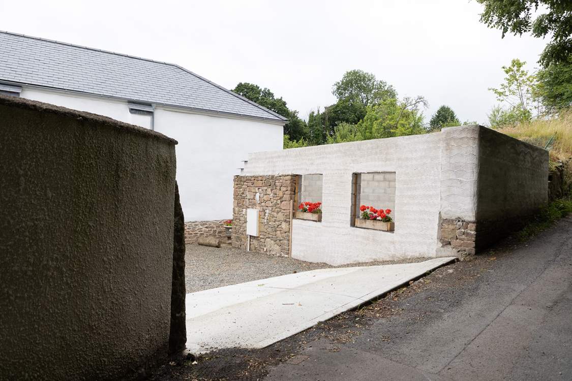 Pull off the lane into the parking courtyard.  Please note the building works have ceased with just the shell being visible.