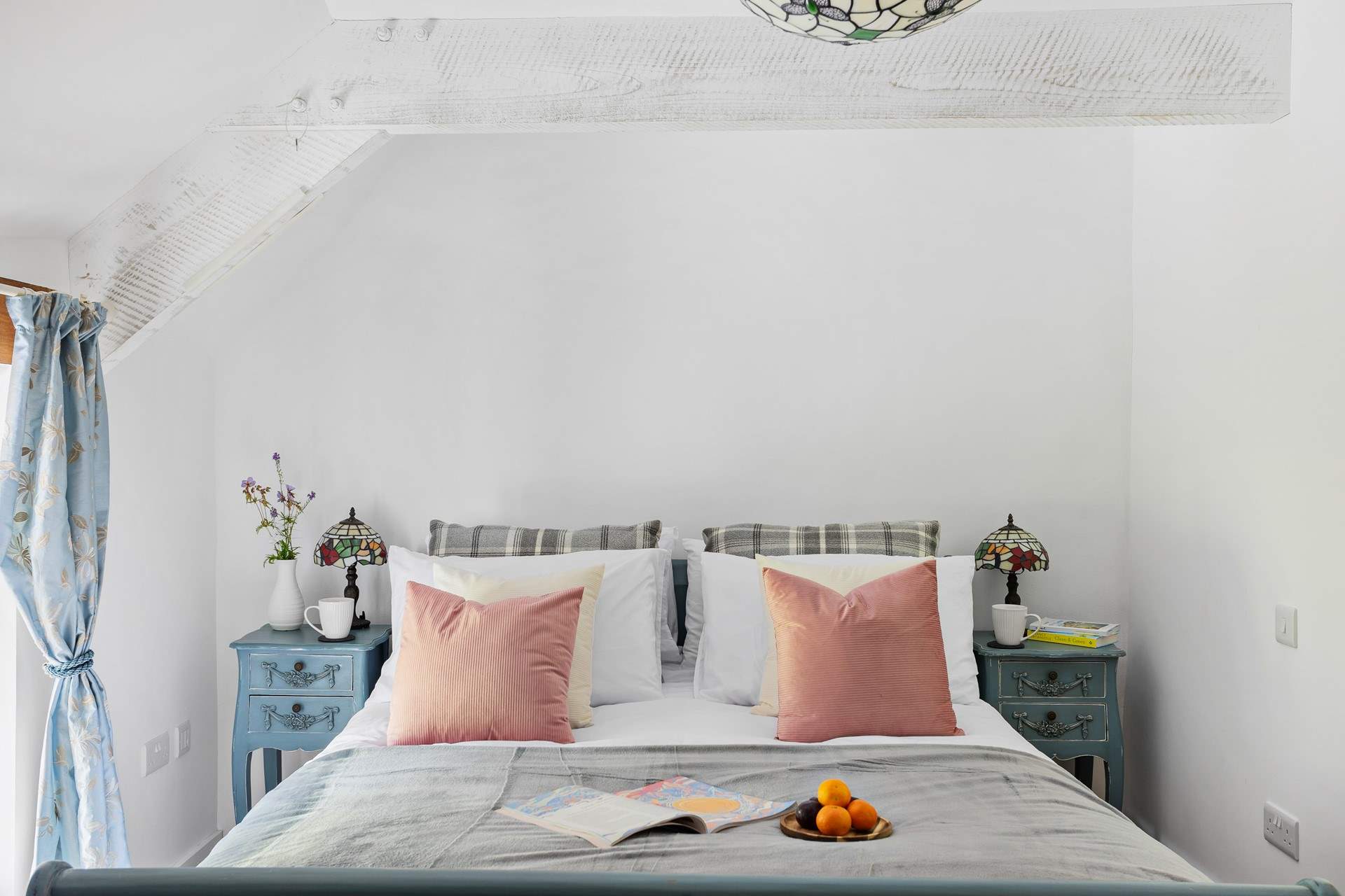 This gorgeous bedroom has views out across the garden.