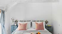 This gorgeous bedroom has views out across the garden.