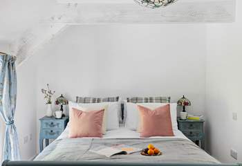 This gorgeous bedroom has views out across the garden.
