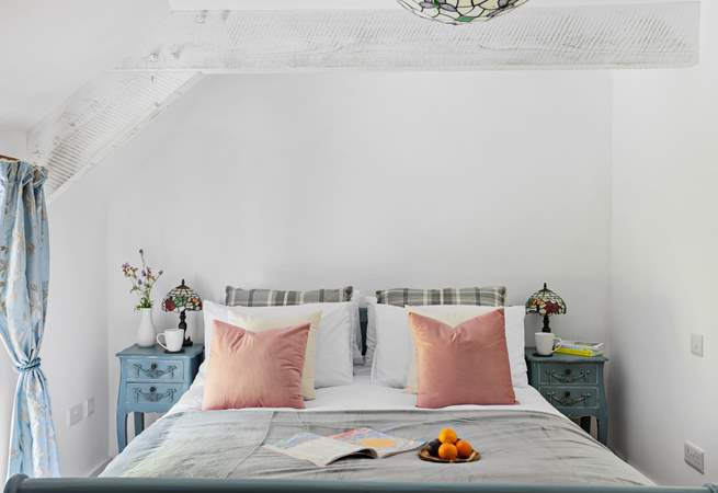 This gorgeous bedroom has views out across the garden.