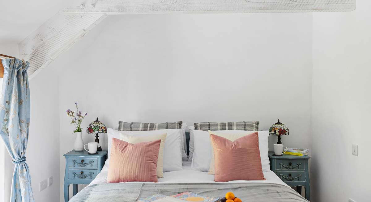 This gorgeous bedroom has views out across the garden.