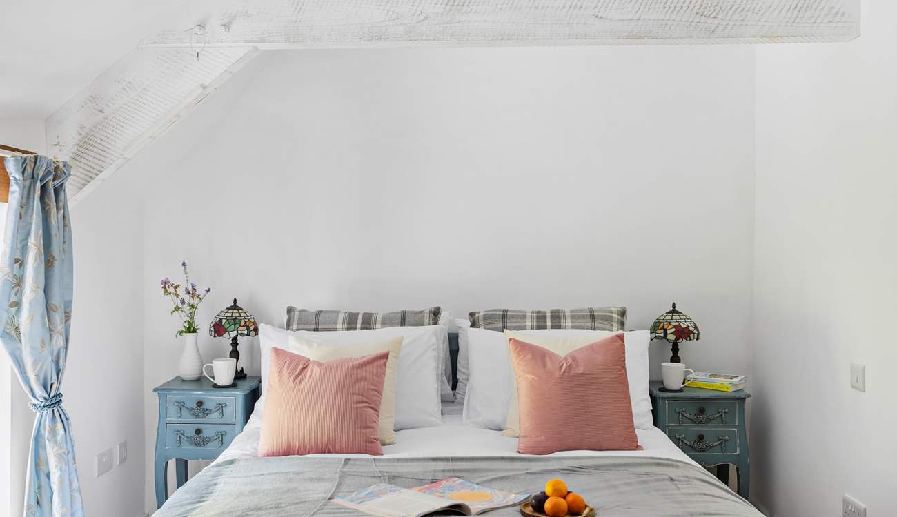 This gorgeous bedroom has views out across the garden.