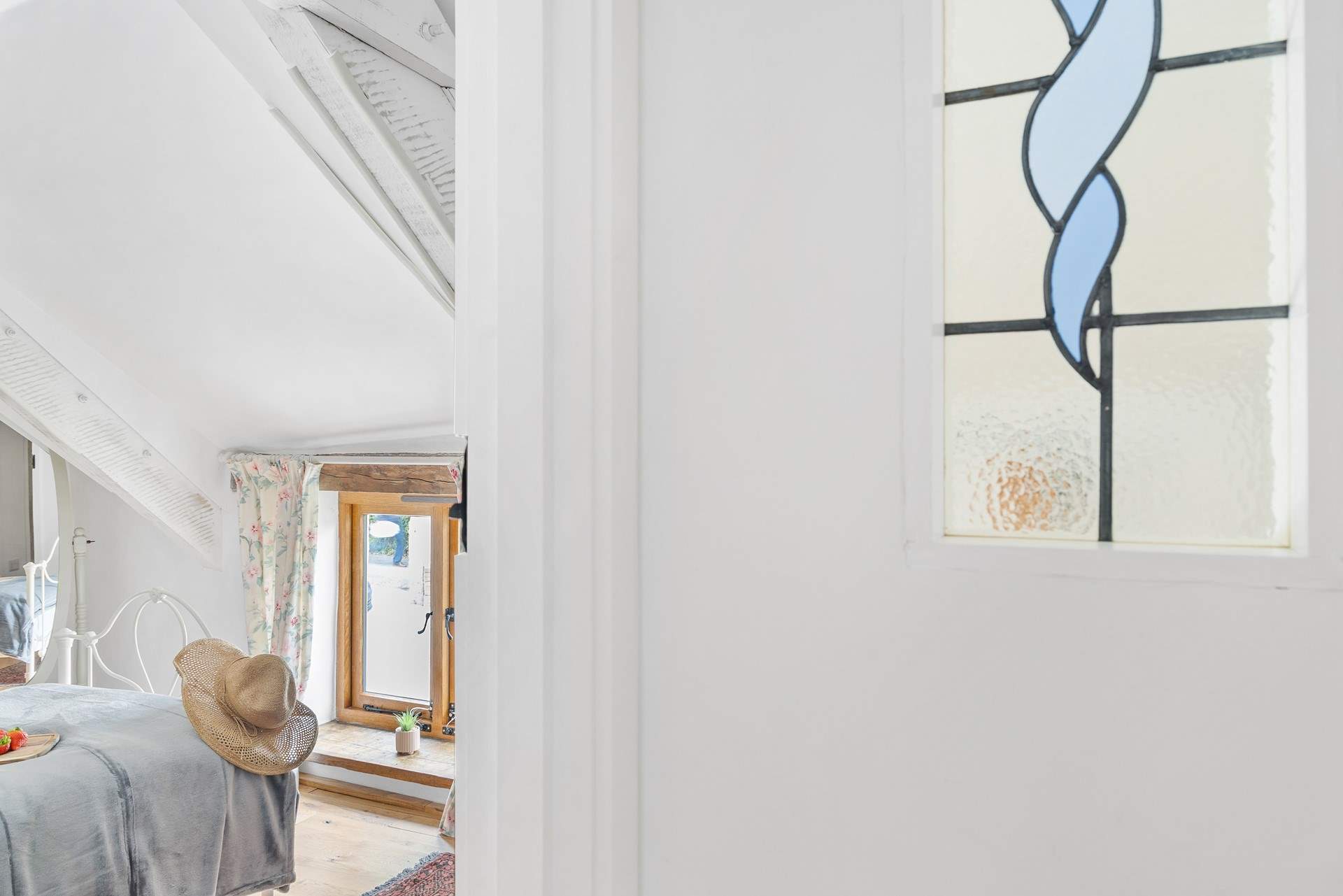 The landing has a reclaimed stained glass window.