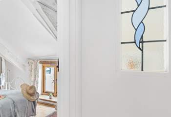 The landing has a reclaimed stained glass window.