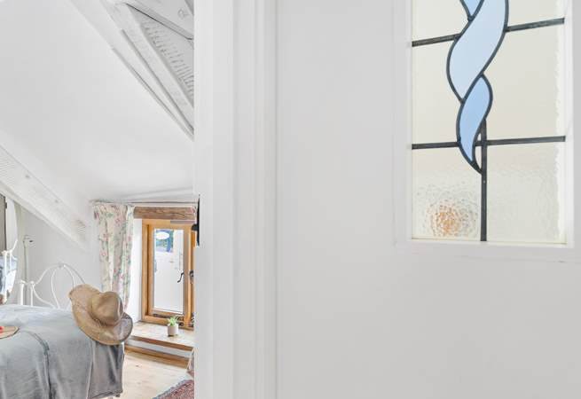 The landing has a reclaimed stained glass window.