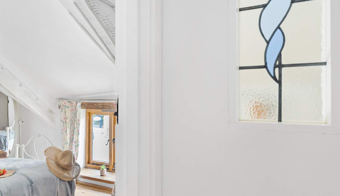 The landing has a reclaimed stained glass window.