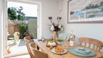 The dining-area enjoys French doors leading out to the garden.