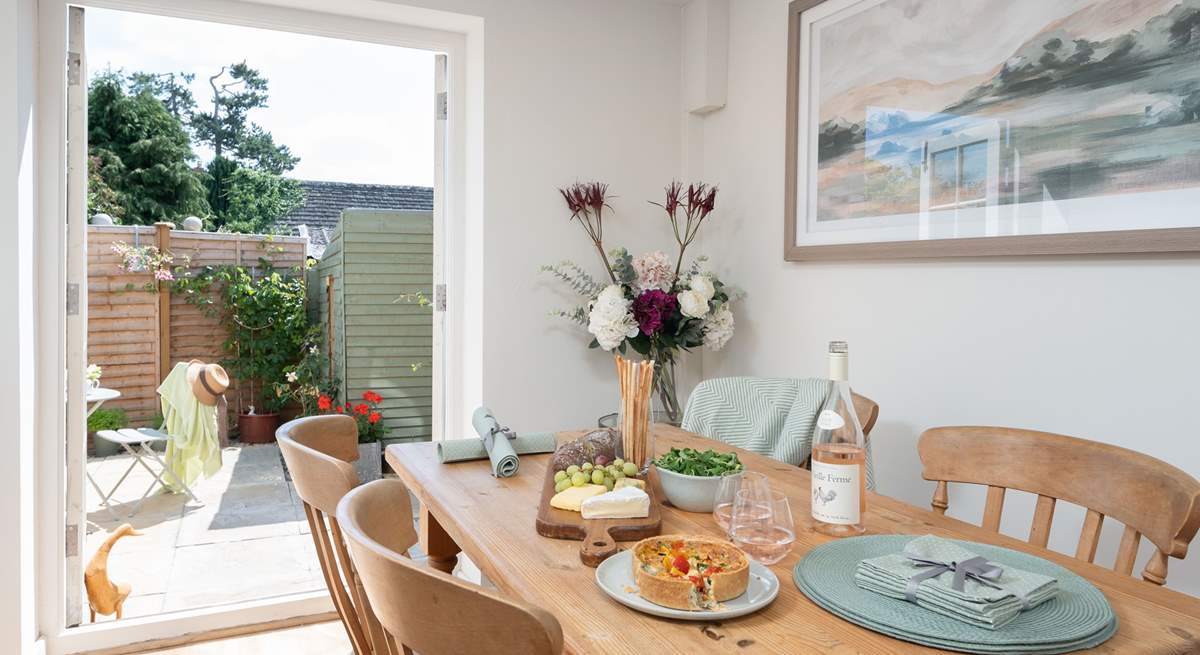 The dining-area enjoys French doors leading out to the garden.