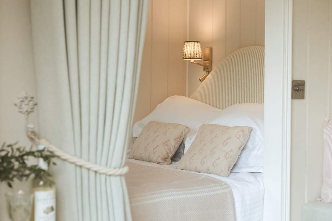 The sumptuous king-sized bed promises sweet slumbers.