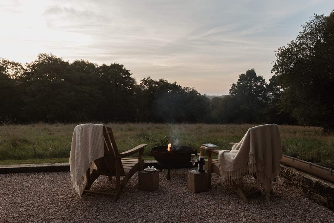 As the evening sun drops, get cosy around the fire pit.