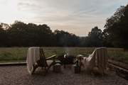 As the evening sun drops, get cosy around the fire pit.