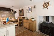 Admire the original beams and the stone wall of the cottage.
