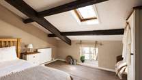 This large single bedroom has views over the cobbled street below.