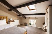 This large single bedroom has views over the cobbled street below.