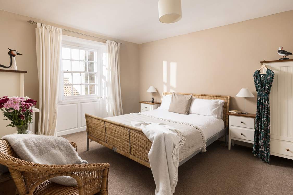 This comfy room has light flooding in.