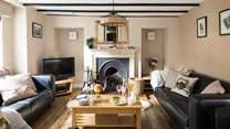 Cosy up in the sitting-room of Greystones with a traditional fireplace and beams.