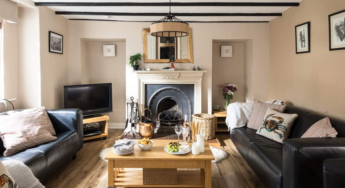 Cosy up in the sitting-room of Greystones with a traditional fireplace and beams.