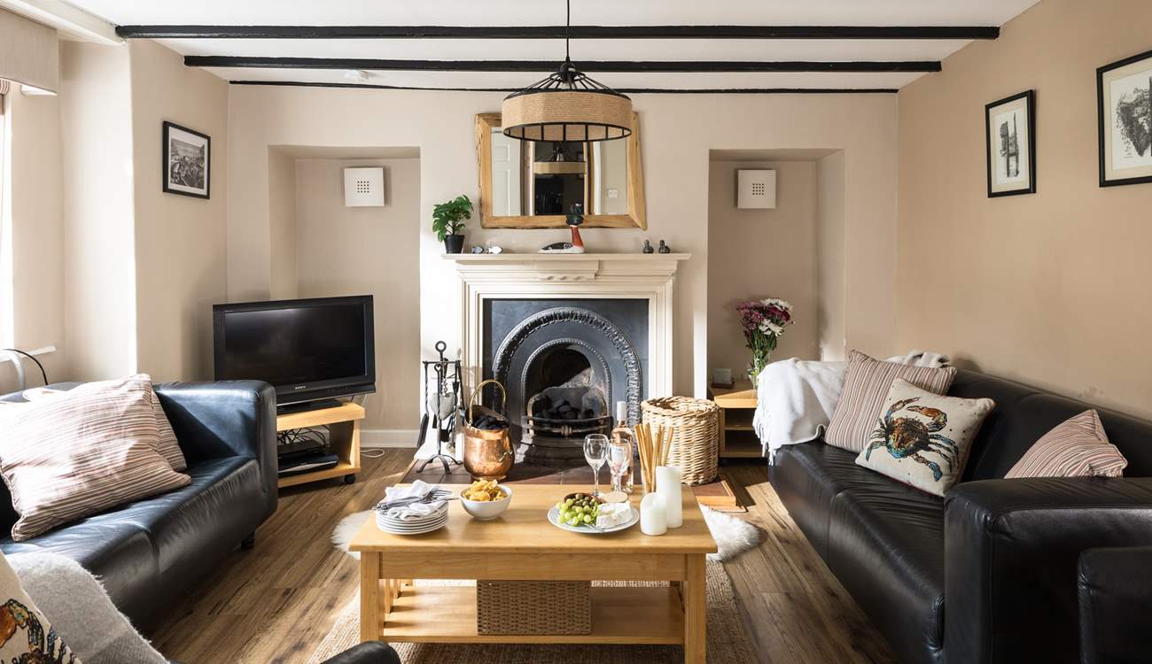 Cosy up in the sitting-room of Greystones with a traditional fireplace and beams.