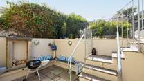 Open the bi-fold doors and step out to the lower courtyard.