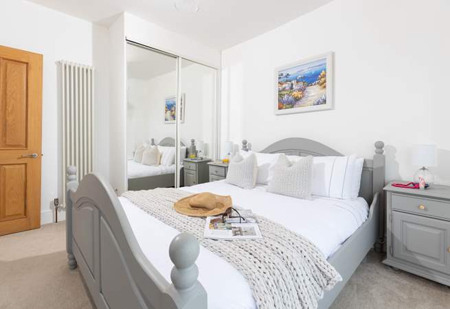 Bedroom 2 offers a calm setting with views of the harbour and a handy en suite shower.