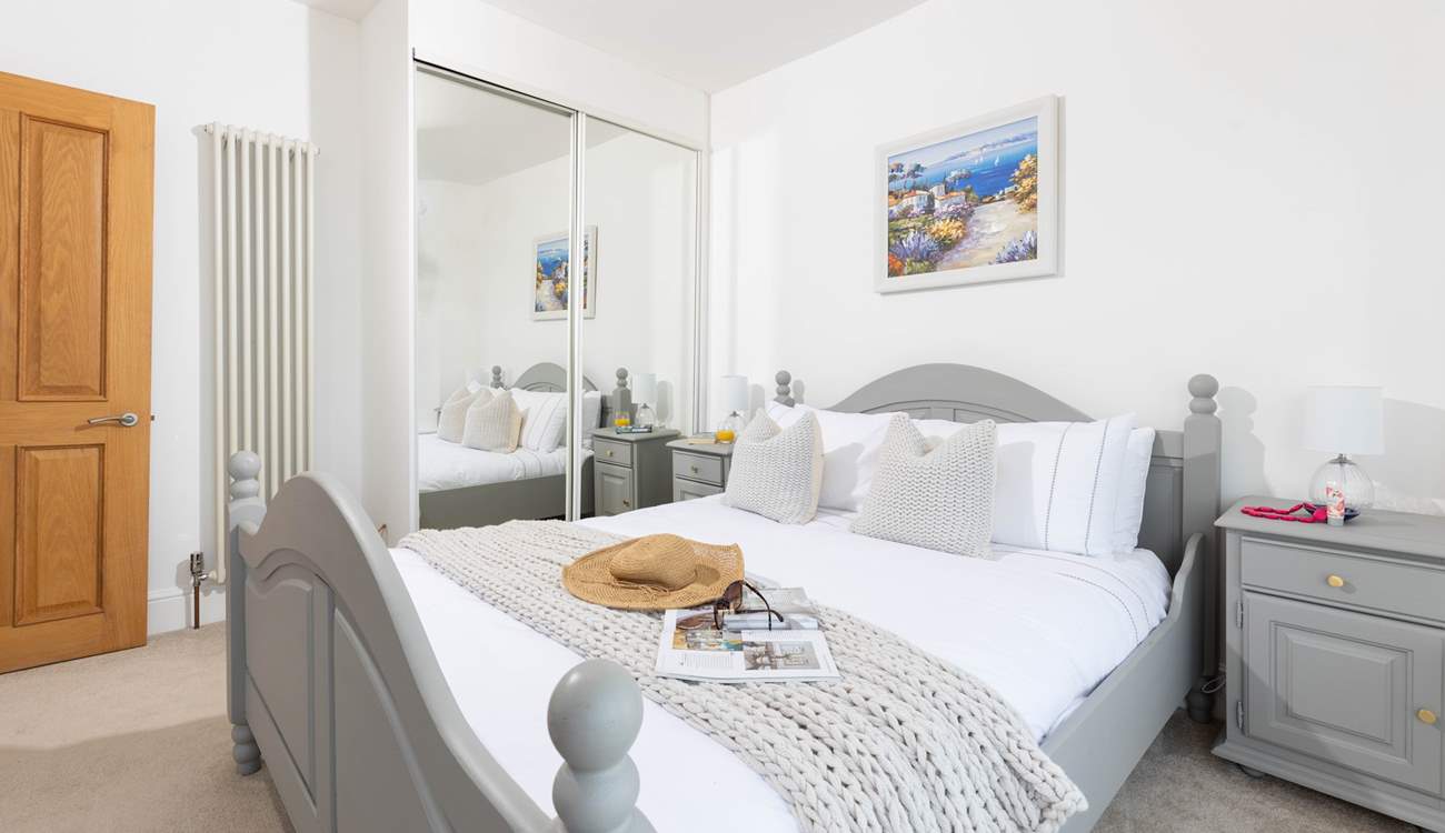 Bedroom 2 offers a calm setting with views of the harbour and a handy en suite shower.