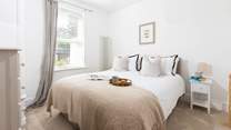Bedroom 1 offers a tranquil setting with views out across the garden.