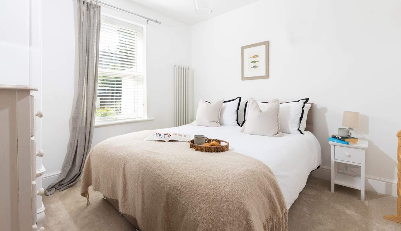 Bedroom 1 offers a tranquil setting with views out across the garden.